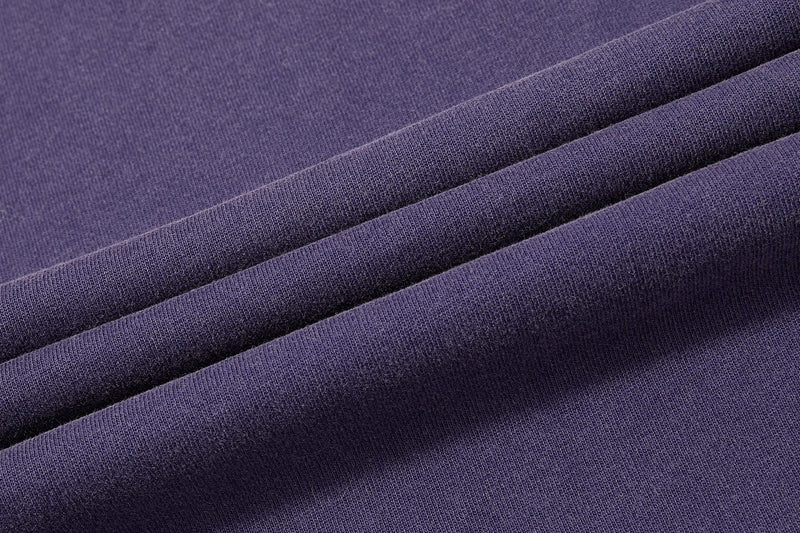 Close-up of purple washed tee fabric with soft folded texture for vintage streetwear style