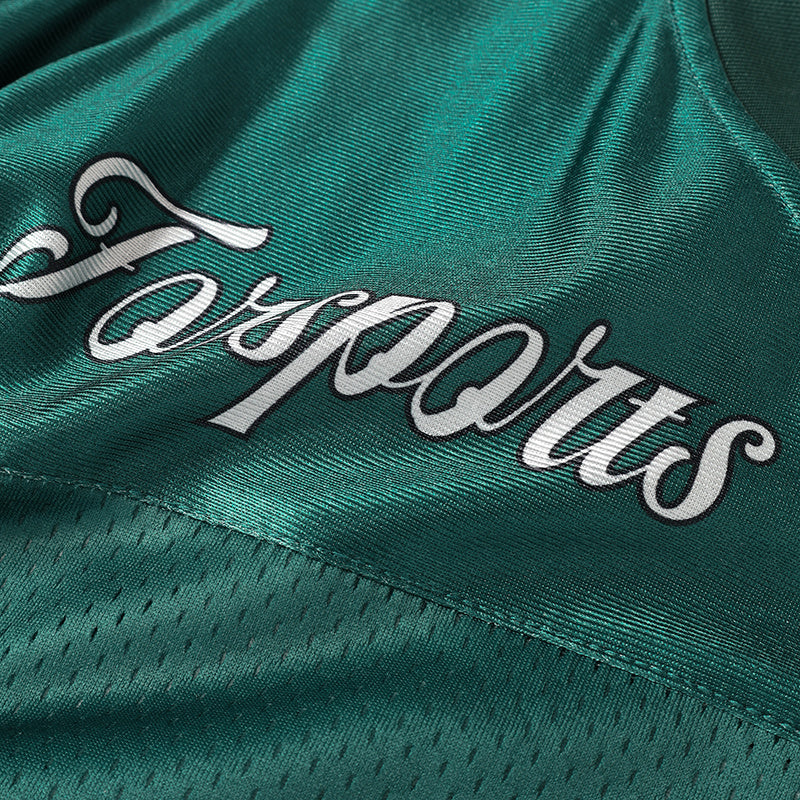 Close-up of a teal vintage football jersey with a white Sports script logo and textured mesh fabric detail