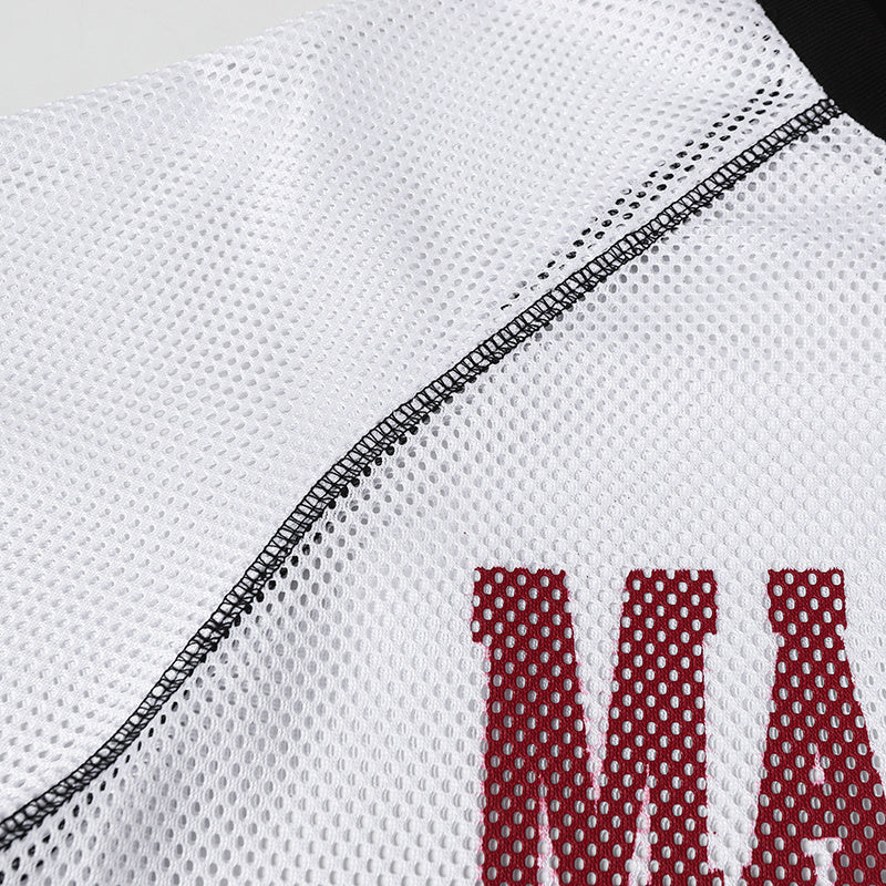 Close-up of white breathable mesh varsity jersey with black stitching and red lettering detail