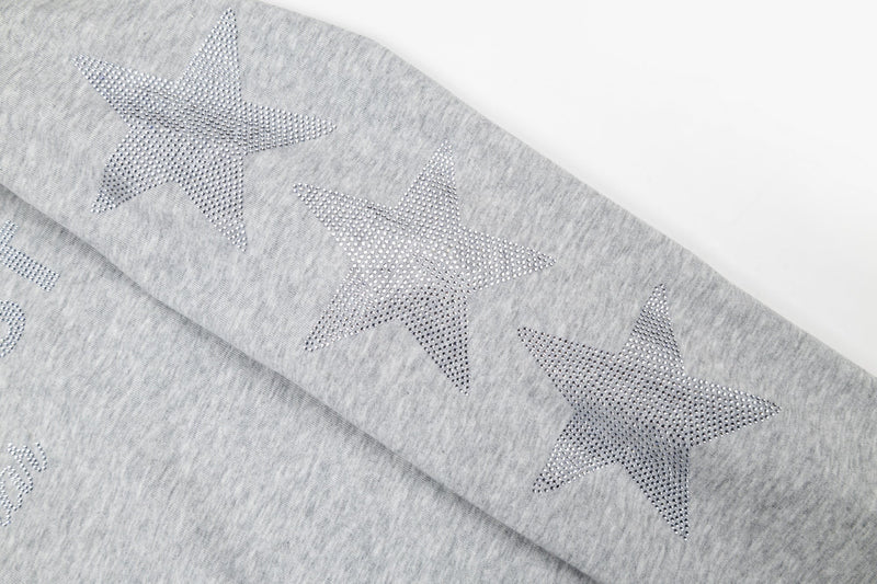 Close-up of rhinestone star print on heather gray sleeve