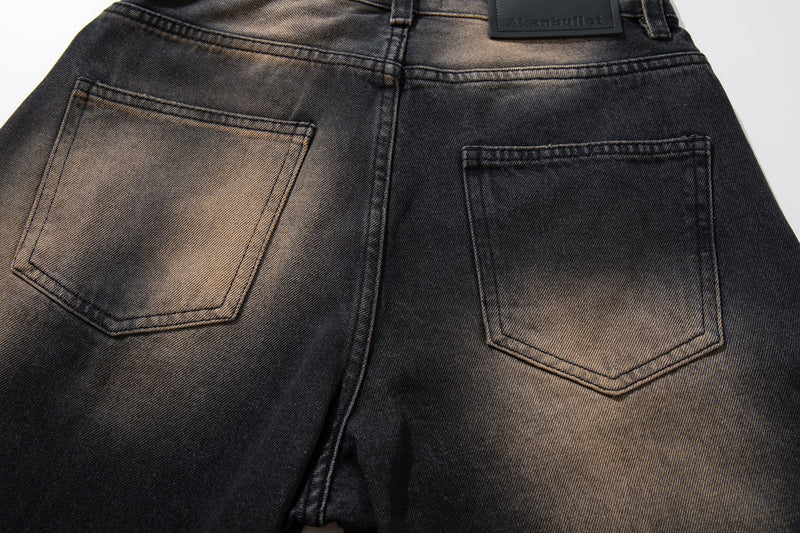 Back waistband close-up of black fade wide-leg jeans with two patch pockets and brand patch