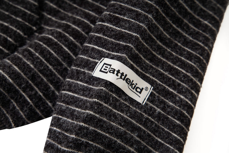 Close-up of Battlekid side label on black striped knit sleeve