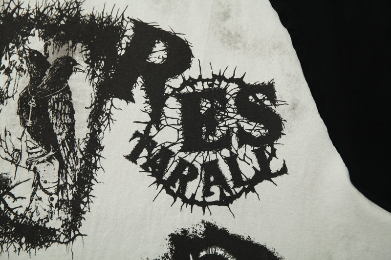Distressed black-and-white graphic tee with a cracked skull print and raglan sleeve streetwear style