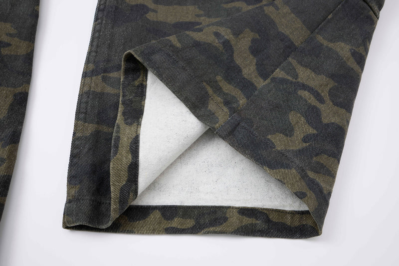 Close-up of camo cargo pants leg opening with folded hem and white lining visible