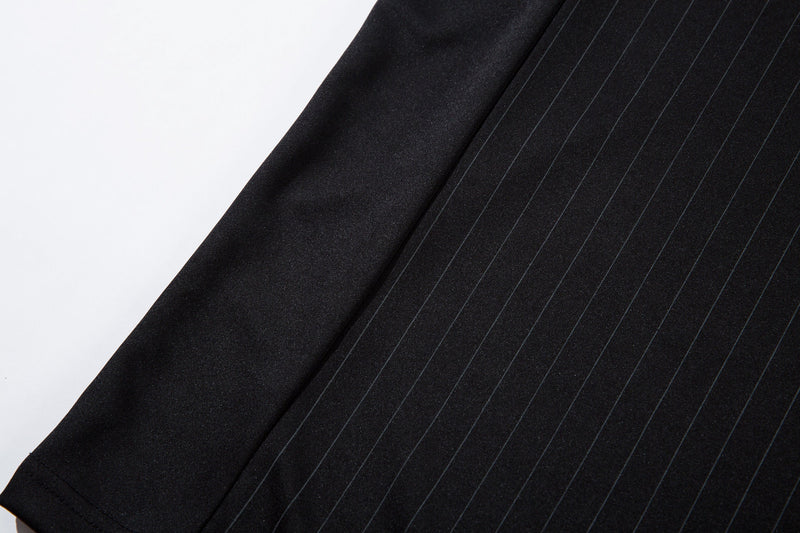Close-up of black jersey sleeve and side panel with pinstripe fabric