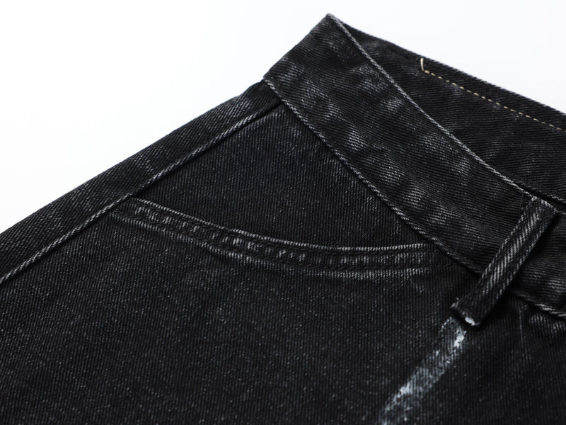 Close-up of black denim waistband seam and stitching on the upper back