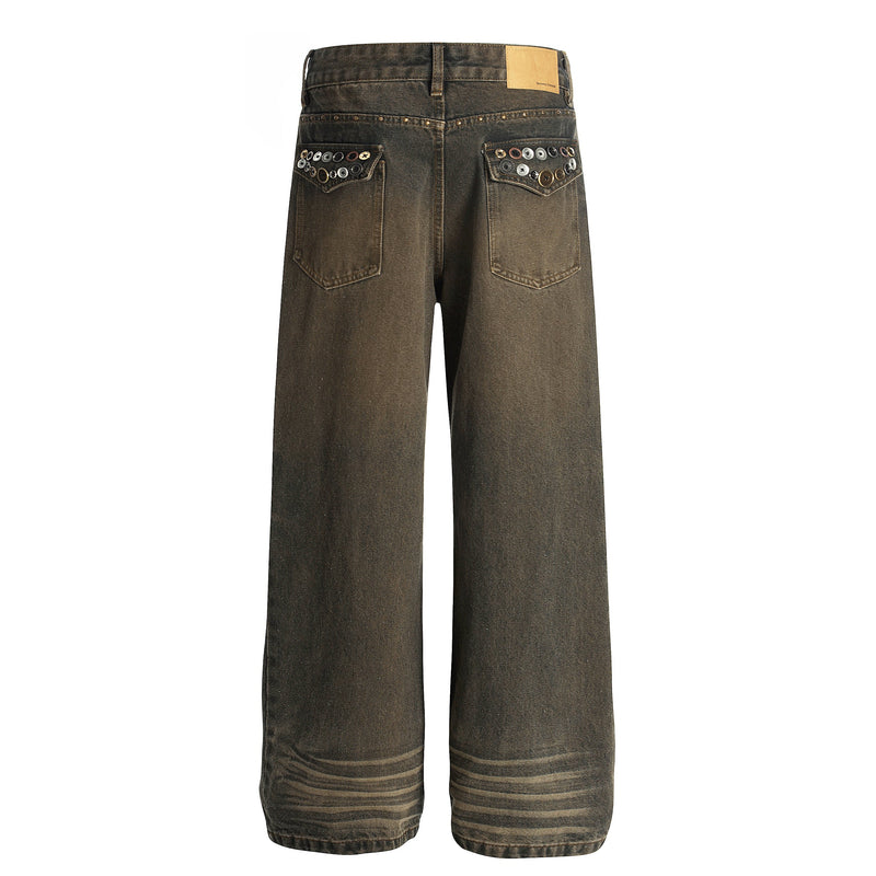 Back view of dark faded jeans with studded back pockets and tan label at waistband