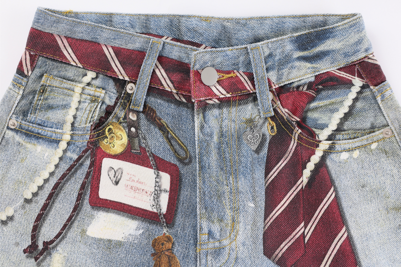 Close-up of the front waist with red striped belt loops, keychains, and layered denim details