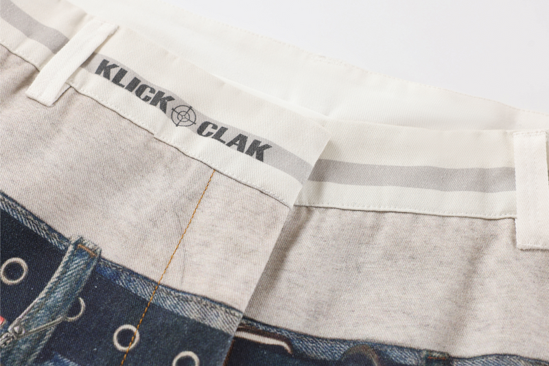 Close-up of the back waistband with white trim and KLICK CLAK print