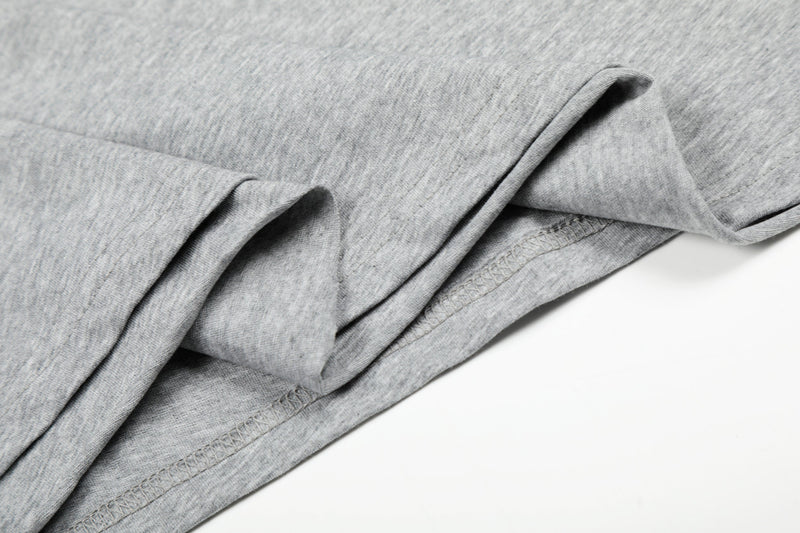 Gray sleeve and hem close-up with folded fabric detail