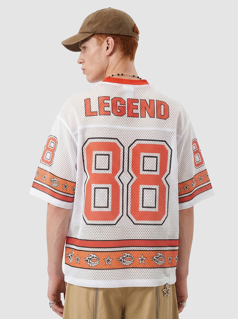 Back view of a white mesh jersey T-shirt with orange 88 graphic, Legend lettering, and varsity streetwear details