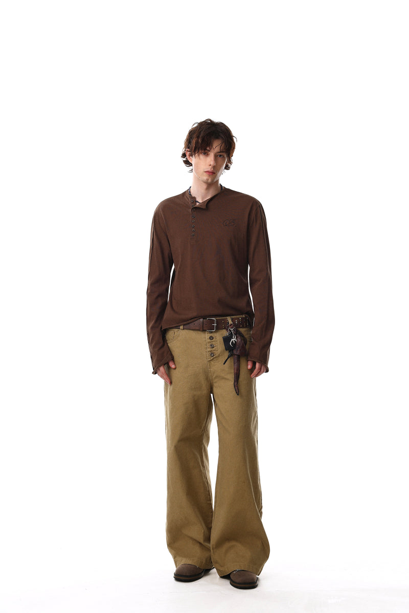 Full-length model view wearing brown Henley T-shirt with tan pants and belt details