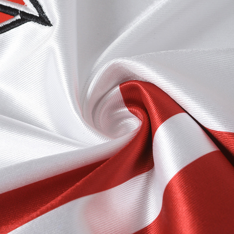 Close-up of a white and red varsity football jersey fabric with stitched detailing and a retro streetwear look