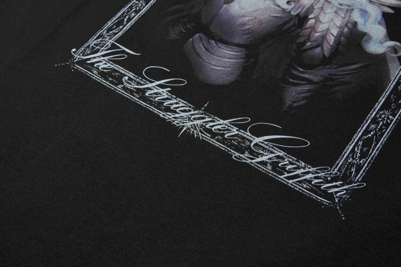 Black graphic T-shirt with a crystal angel print and ornate script frame in a moody streetwear style