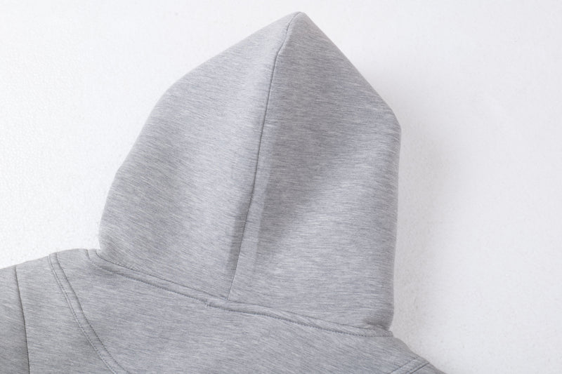 Close-up of light gray hoodie hood seam and pointed top