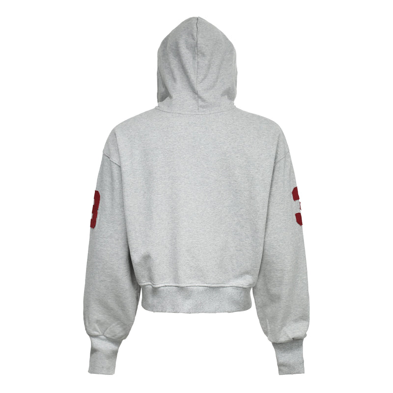 Light gray zip hoodie back view with red sleeve patches and cropped hem