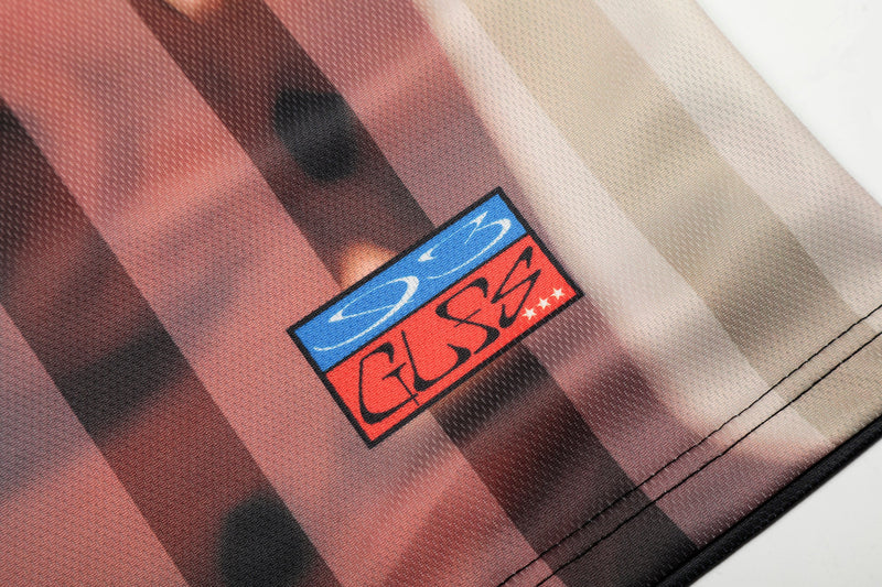 Abstract portrait print on mesh jersey with vertical pink, brown, and beige stripes and a bold graphic patch