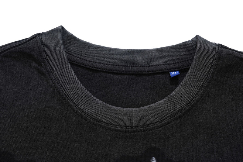 Black vintage wash graphic T-shirt with ribbed crew neck and visible XL size tag on a white background
