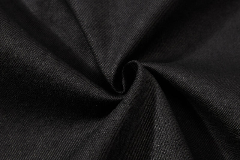 Close-up of black twill fabric texture on cargo shorts