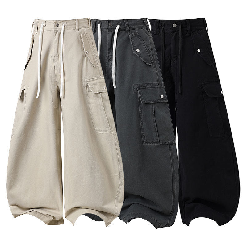 Beige wide-leg cargo barrel pants with flap pockets, drawstring waist, and gathered hem displayed flat on white background