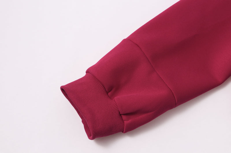 Close-up of burgundy ribbed cuff and sleeve hem on zip hoodie