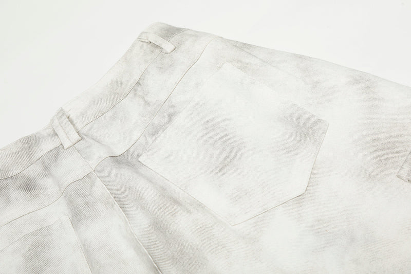 Close-up of the back pocket and waistband details on white washed cargo pants