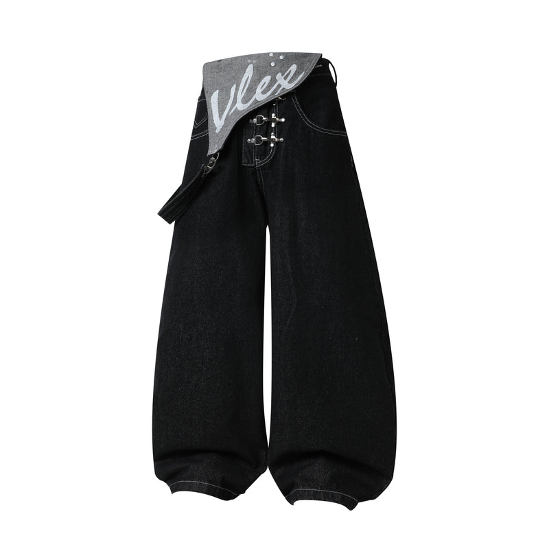 Black wide-leg jeans with silver buckle front straps and gray printed flap waistband detail
