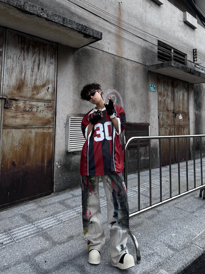 Retro vertical stripe soccer jersey tee with number 30 worn as an oversized streetwear top in burgundy, black, and white