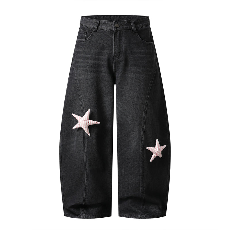 Black wide-leg jeans with pink star patches, front view