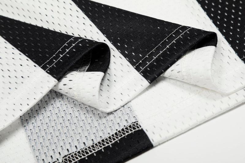 Close-up of sleeve fabric folds on black and white striped jersey with stitched seams