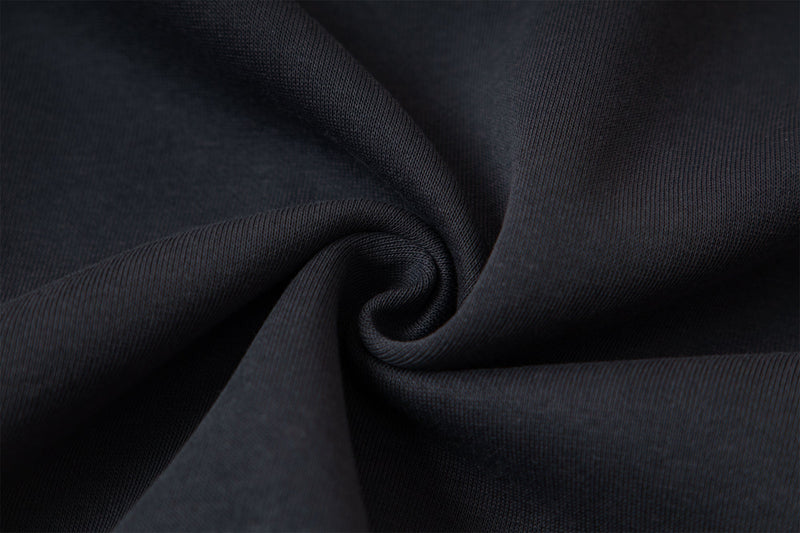 Close-up of black hoodie fabric texture with gathered folds