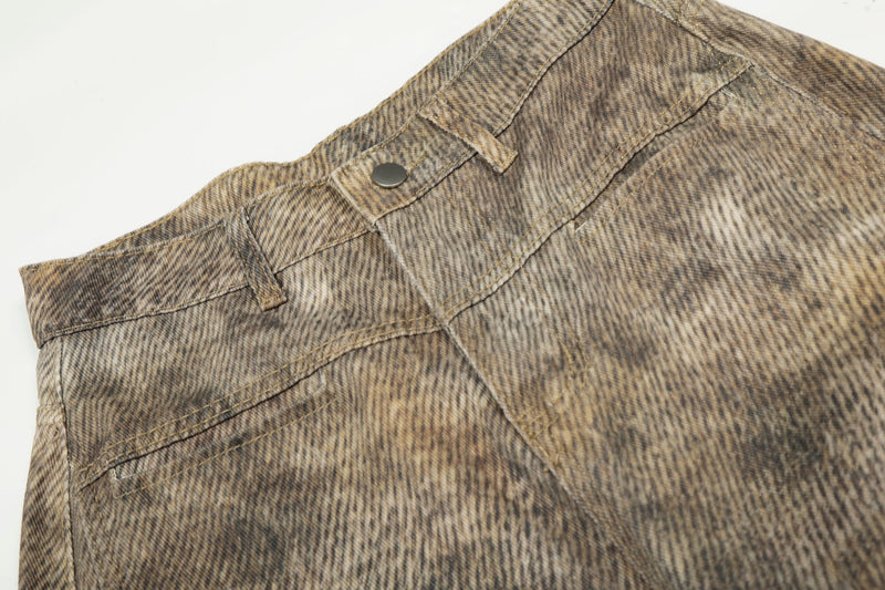Close-up of denim waistband with button, belt loops, and top stitching