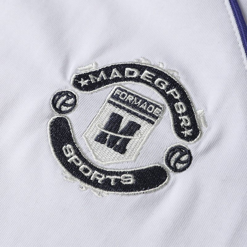 Embroidered Madegr Sports crest on white football jersey T-shirt with purple trim detail