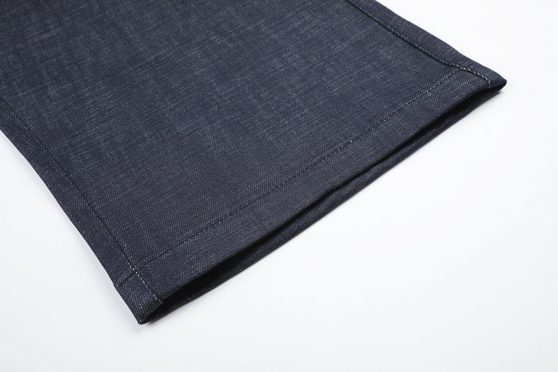 Hem detail of dark wide-leg jeans with straight stitched cuff