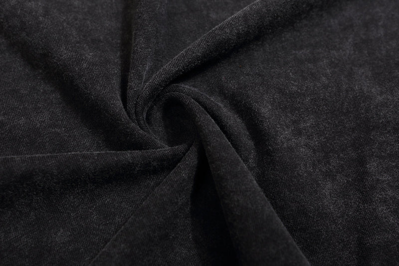 Close-up of black fabric texture on distressed sweatshirt