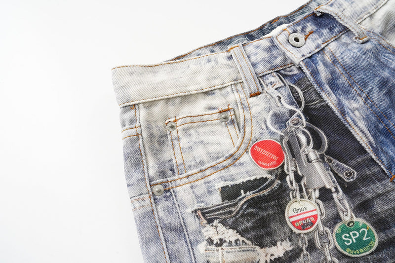 Close-up of the front pocket area on light and dark patchwork denim with chain detail