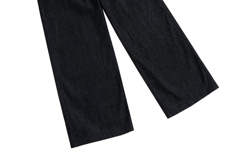 Lower legs of black wide-leg jeans with straight hems