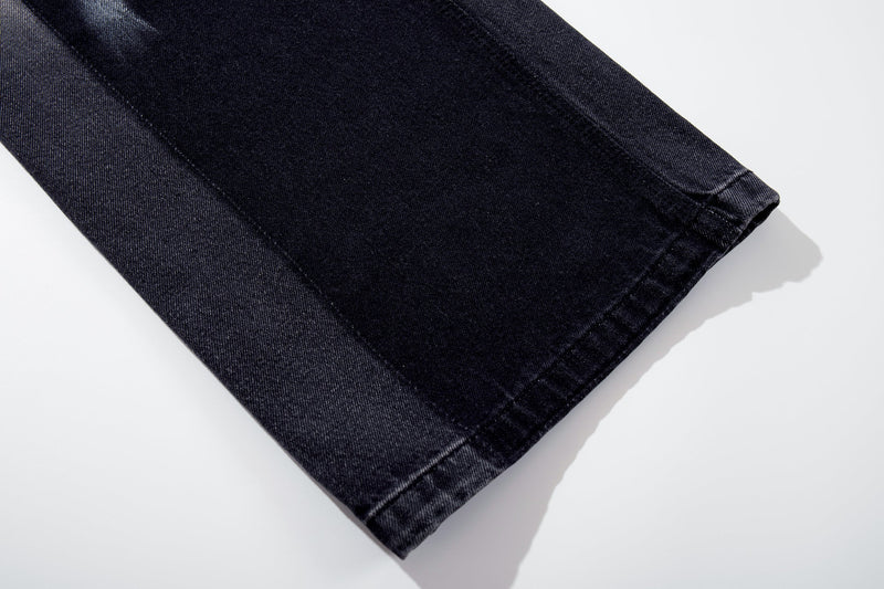 Cuffed hem close-up on dark wash wide-leg denim jeans