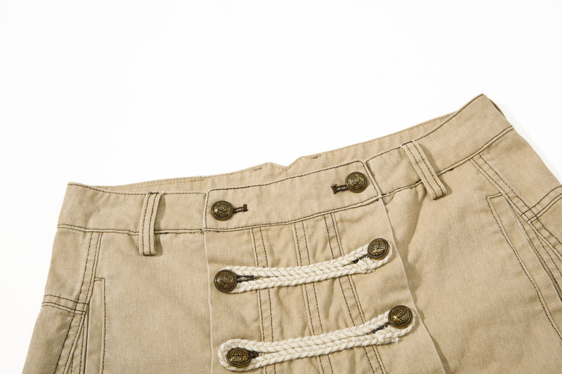 Close-up of khaki waistband and front closures with belt loops and leather patch