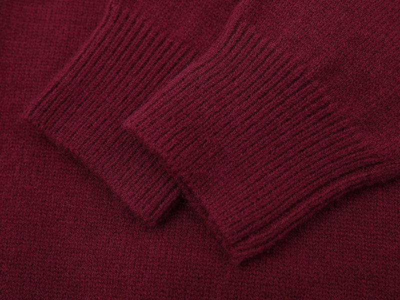 Close-up of burgundy knit sleeve cuff and ribbed fabric texture