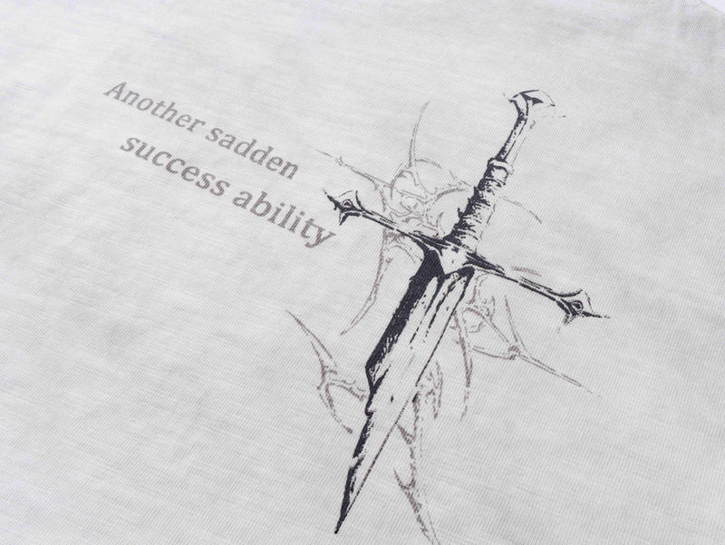 Close-up of back graphic on white tee with cross sketch and printed text
