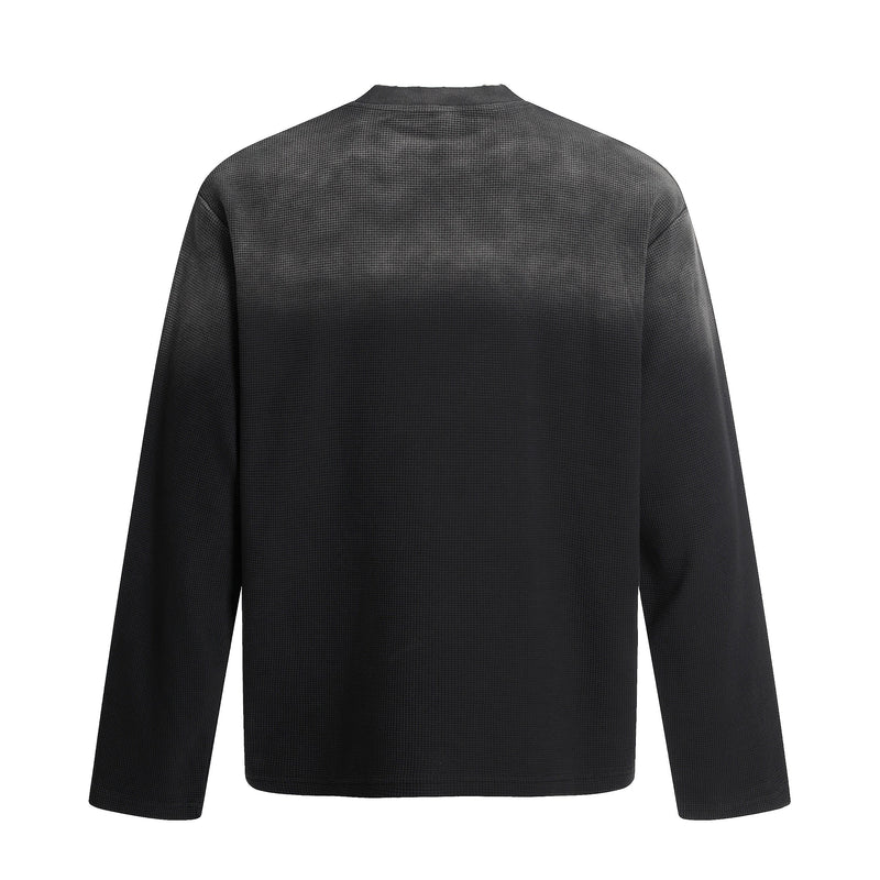 Back view of black waffle knit long sleeve tee with plain solid back