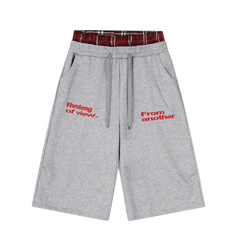 Gray streetwear shorts with red plaid waistband and red embroidered front text