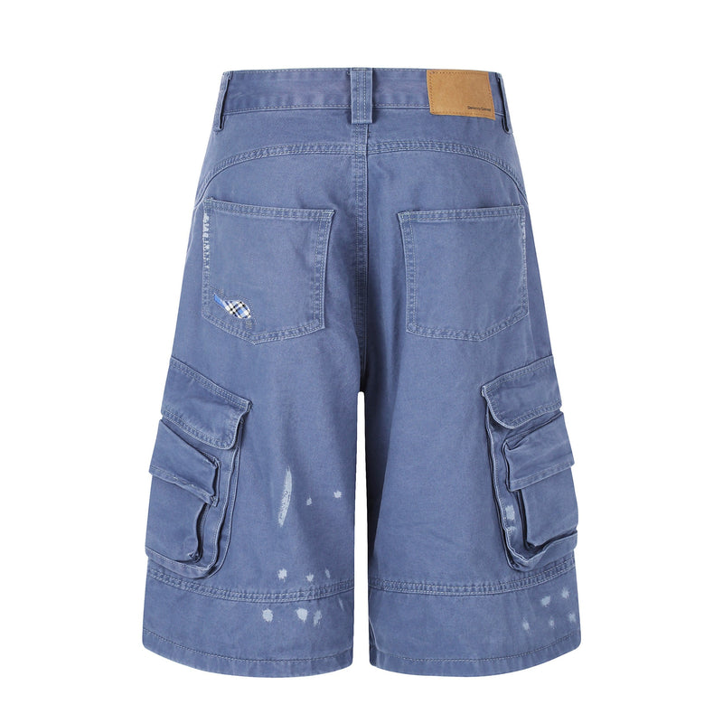 Back view of blue cargo shorts with patch pockets and distressed holes