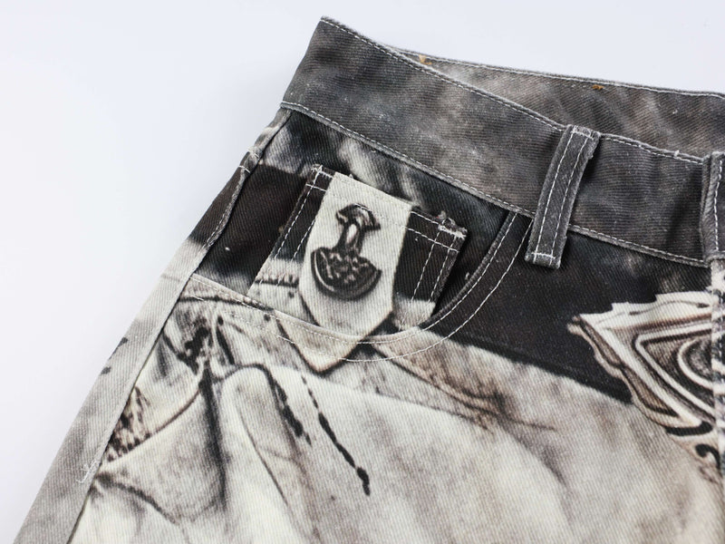 Close-up of front pocket and waistband on black-and-white abstract wash denim