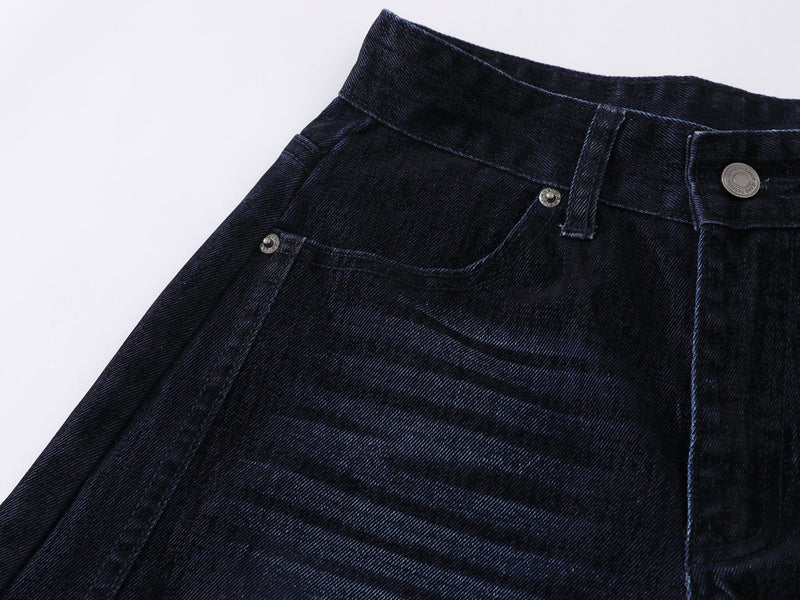 Close-up of the front hip pocket area on faded indigo denim pants