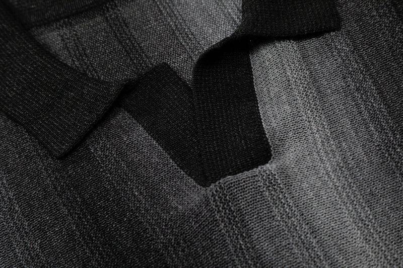 Close-up of a men's open-knit polo with black and gray gradient stripes and textured relaxed-fit fabric