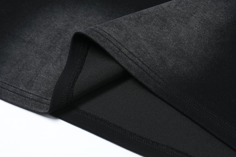 Close-up of hem and stitching on black washed long sleeve tee