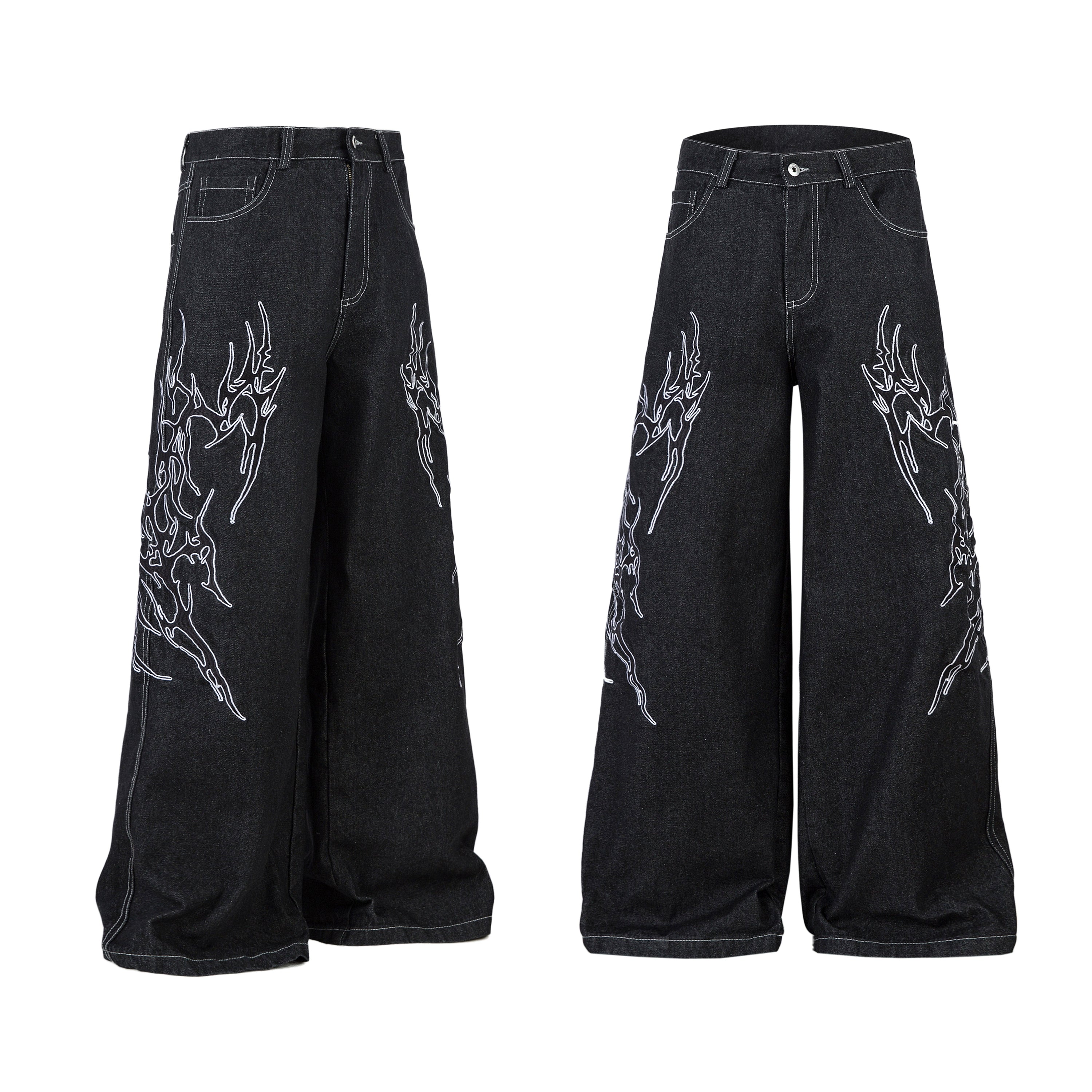 Front view of black wide-leg denim jeans with white tribal embroidered graphics on both legs