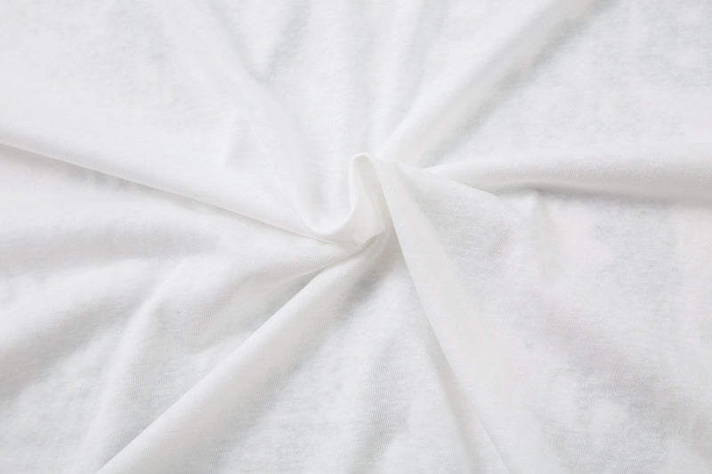 Close-up of plain white fabric with soft folds and texture